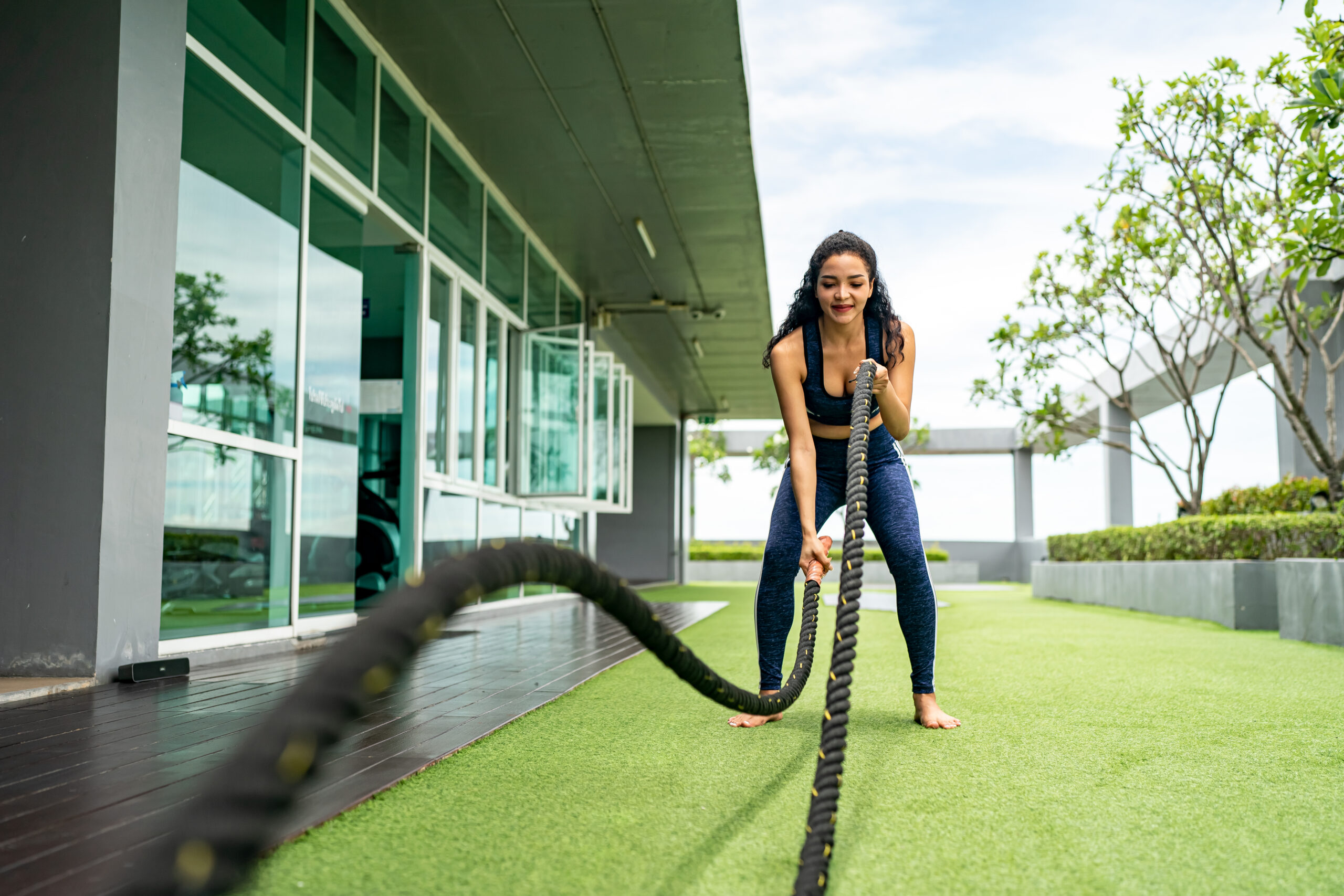 Young woman Training with Battle Rope